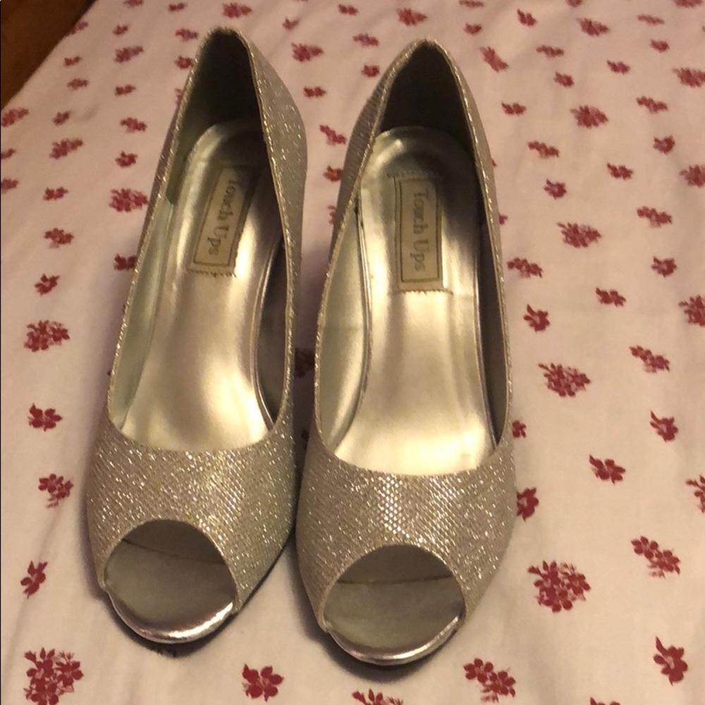 Glittery open toe high heels.